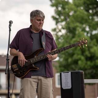 Shirky playing bass on stage.